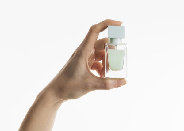 Hand holding a perfume bottle
